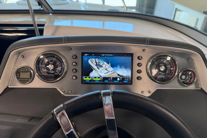 Slide: The Image of Dashboard of a 2016 Regal 2550 Cuddy boat with digital display and gauges. - 17