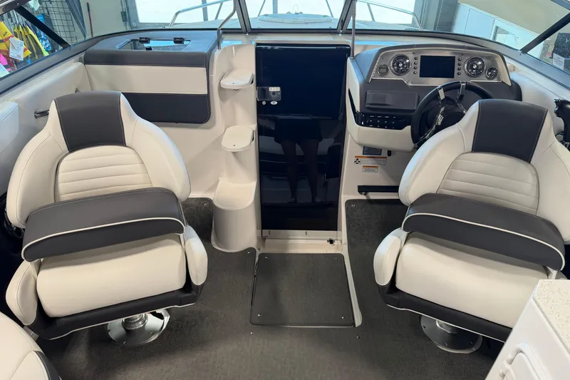 Slide: The Image of Interior of a 2016 Regal 2550 Cuddy boat with modern seating and dashboard. - 19