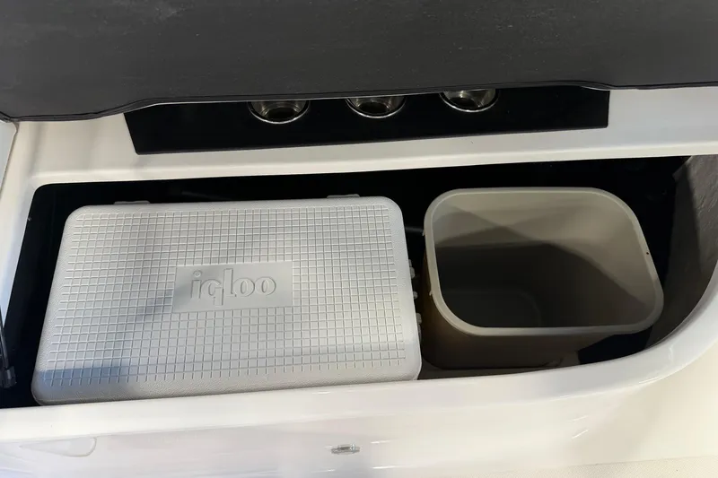 Slide: The Image of Storage compartment in a 2016 Regal 2550 Cuddy boat with Igloo cooler and bin. - 21