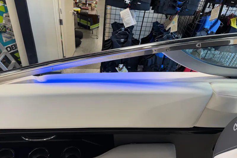 Slide: The Image of 2016 Regal 2550 Cuddy interior with blue LED lighting and sleek design elements. - 22
