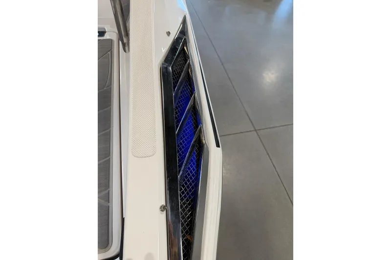 Slide: The Image of 2016 Regal 2550 Cuddy boat detail with blue-lit vent and sleek design. - 25