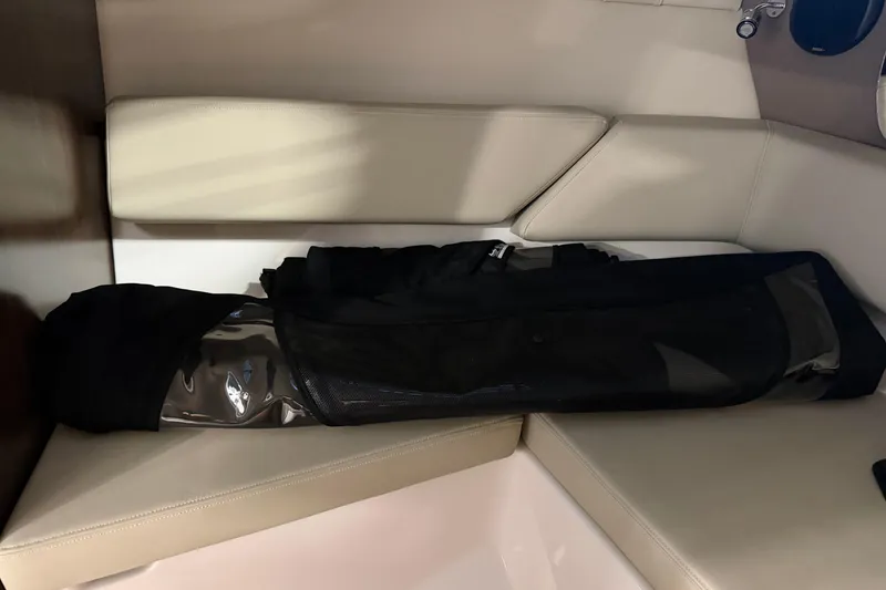 Slide: The Image of Cuddy cabin interior of 2016 Regal 2550 boat with beige seating. - 27