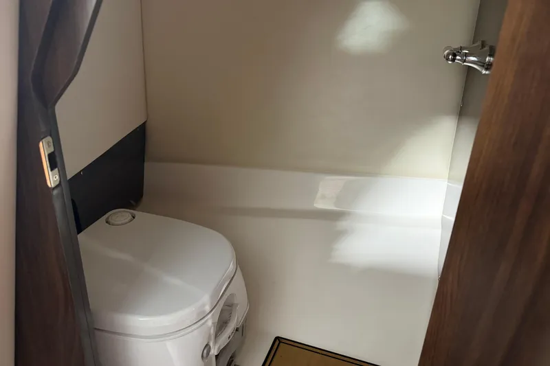 Slide: The Image of 2016 Regal 2550 Cuddy boat interior with compact toilet. - 29