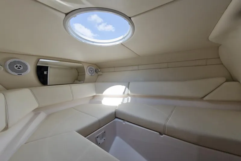 The Image of Manufacturer Provided Image: 2016 Regal 2550 Cuddy cabin interior with skylight and beige seating. - 3