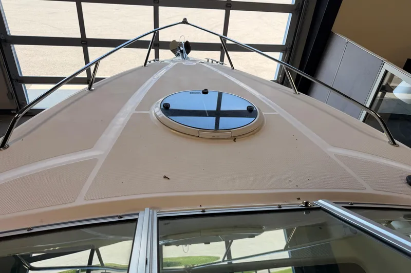 Slide: The Image of 2016 Regal 2550 Cuddy boat deck with hatch, viewed from inside a garage. - 30