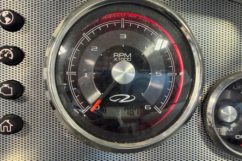 Slide: The Image of Close-up of a 2016 Regal 2550 Cuddy tachometer displaying RPM and control buttons. - 31