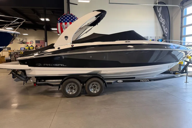 Slide: The Image of 2016 Regal 2550 Cuddy boat on trailer in showroom setting. - 5
