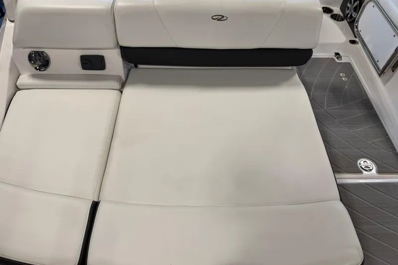 Slide: The Image of 2016 Regal 2550 Cuddy boat interior with white cushioned seating. - 9