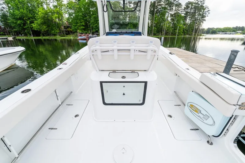 Slide: The Image of Manufacturer Provided Image: 2026 Sea Hunt Gamefish 27 boat interior with forward seating, docked by a serene lake. - 12
