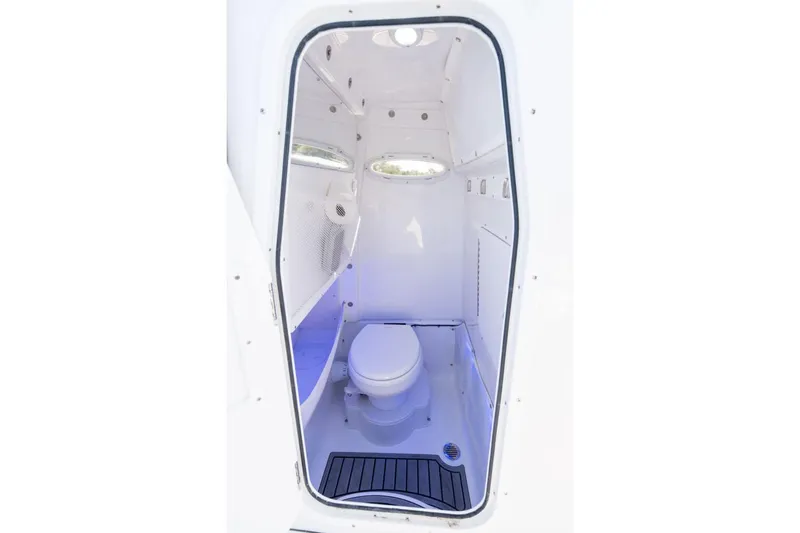 Slide: The Image of Manufacturer Provided Image: 2026 Sea Hunt Gamefish 27 boat interior with compact marine toilet. - 14