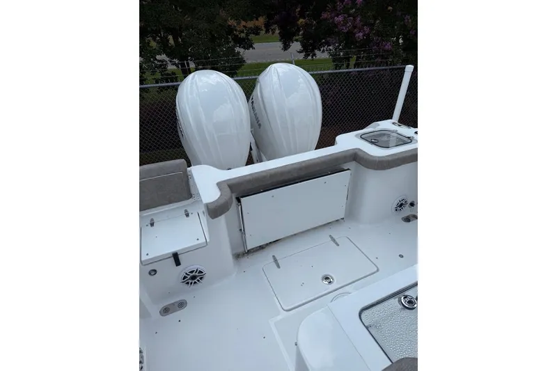 Slide: The Image of 2026 Sea Hunt Gamefish 27 boat deck with dual outboard motors and seating area. - 18