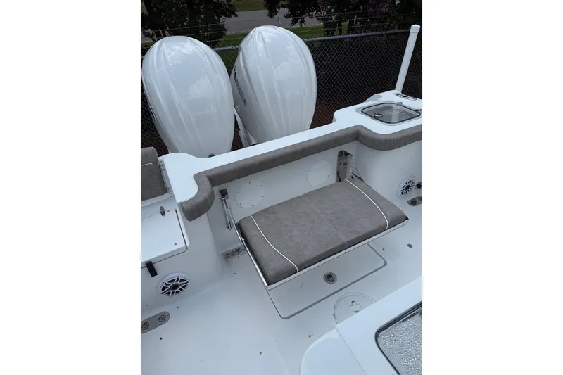 Slide: The Image of 2026 Sea Hunt Gamefish 27 boat with dual engines and cushioned seating. - 19