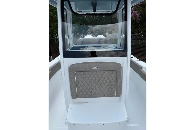 Slide: The Image of 2026 Sea Hunt Gamefish 27 Forward Seating boat interior with cushioned seating and windshield. - 25
