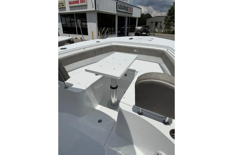 Slide: The Image of 2026 Sea Hunt Gamefish 27 Forward Seating boat interior with table and seating arrangement. - 27