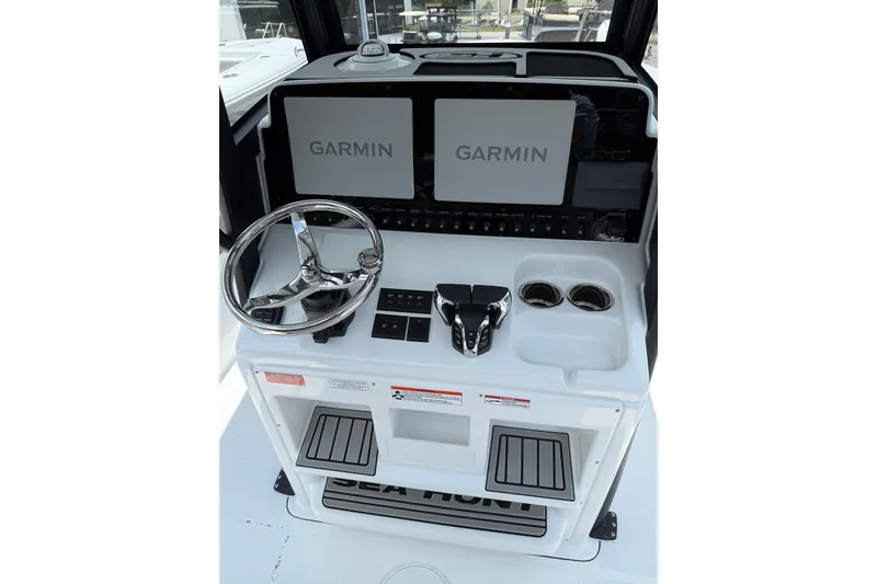 Slide: The Image of 2026 Sea Hunt Gamefish 27 helm with Garmin displays and modern controls. - 28