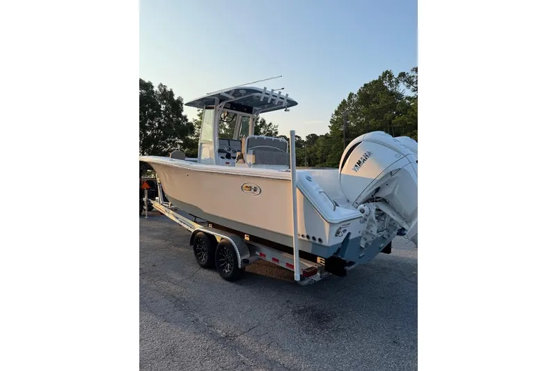 Slide: The Image of 2026 Sea Hunt Gamefish 27 Forward Seating boat with dual Yamaha engines on trailer. - 3