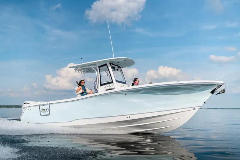 Slide: The Image of Manufacturer Provided Image: 2026 Sea Hunt Gamefish 27 Forward Seating boat cruising on calm water. - 4