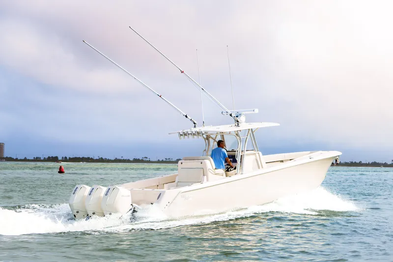 Slide: The Image of 2022 SeaVee 370Z boat cruising on open water with fishing rods. - 11