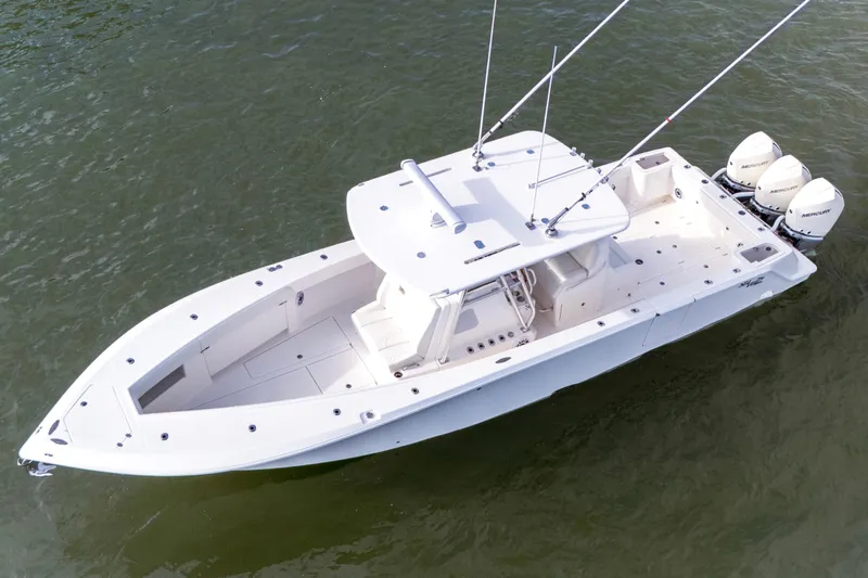 Slide: The Image of 2022 SeaVee 370Z boat with triple outboard engines on calm water. - 12