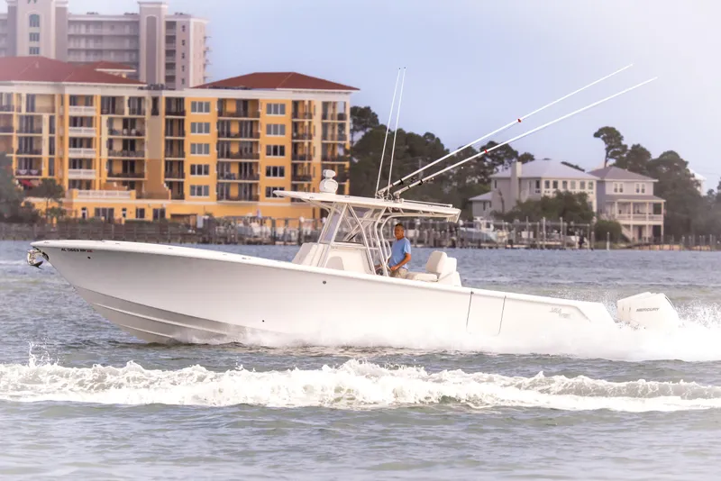 Slide: The Image of 2022 SeaVee 370Z boat cruising on water near coastal buildings. - 13