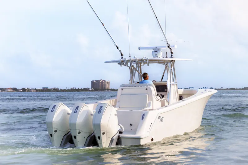 Slide: The Image of 2022 SeaVee 370Z boat with triple outboard engines cruising on water. - 14