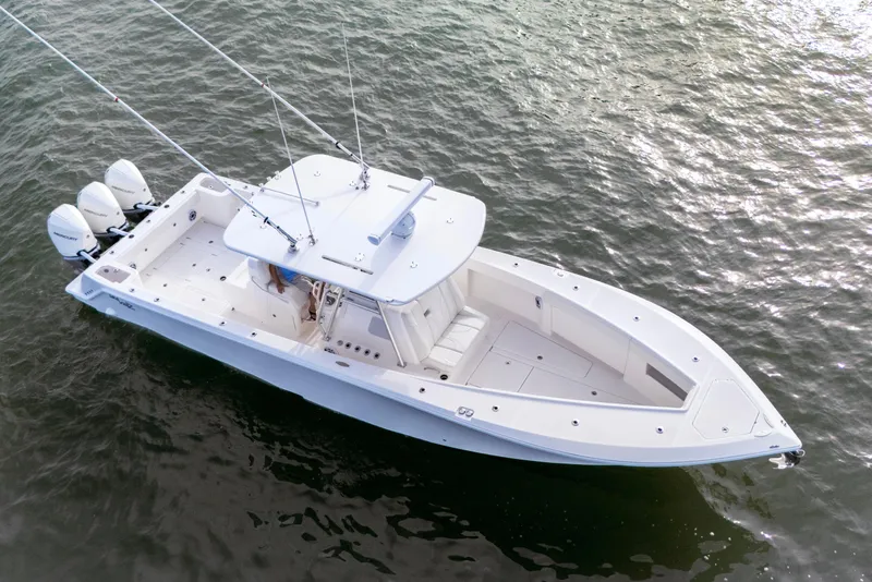 Slide: The Image of 2022 SeaVee 370Z boat with triple outboard engines on calm water. - 16
