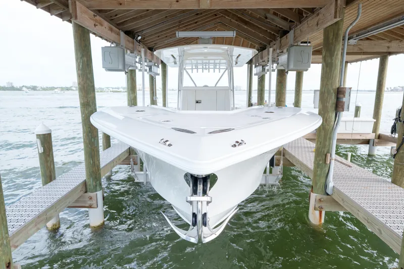 Slide: The Image of 2022 SeaVee 370Z boat docked in a covered marina slip. - 18