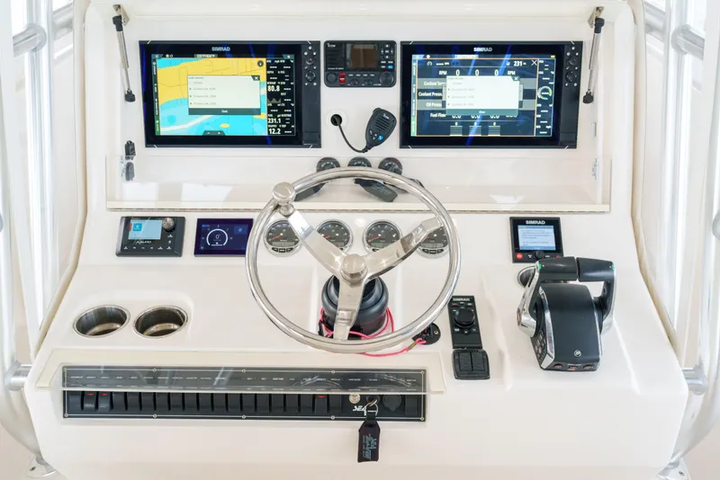 Slide: The Image of 2022 SeaVee 370Z helm with dual Simrad displays and modern controls. - 19