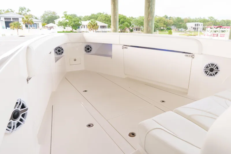 Slide: The Image of 2022 SeaVee 370Z boat interior with sleek white seating and built-in speakers. - 23