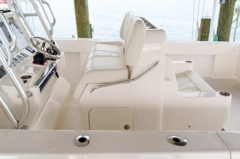 Slide: The Image of 2022 SeaVee 370Z boat interior with white seating and steering console. - 24