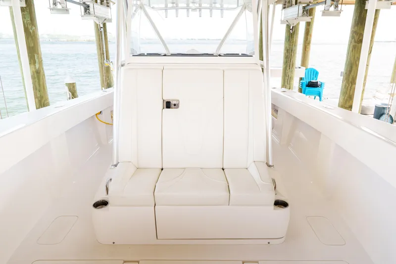 Slide: The Image of 2022 SeaVee 370Z boat interior with white seating, docked by the water. - 26