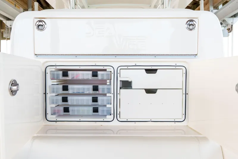 Slide: The Image of 2022 SeaVee 370Z boat storage compartments with organized tackle boxes and drawers. - 31