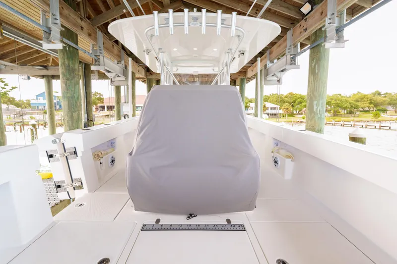 Slide: The Image of 2022 SeaVee 370Z boat under dock, featuring covered console and spacious deck. - 32