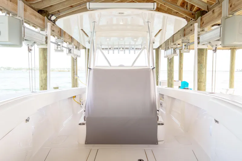 Slide: The Image of 2022 SeaVee 370Z boat interior under wooden dock, showcasing sleek design and spacious layout. - 33