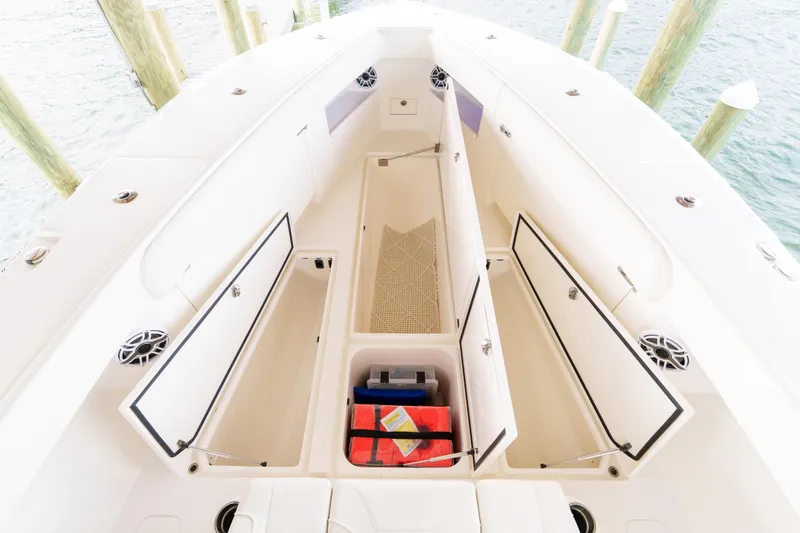 Slide: The Image of 2022 SeaVee 370Z boat interior with open storage compartments and safety equipment. - 34