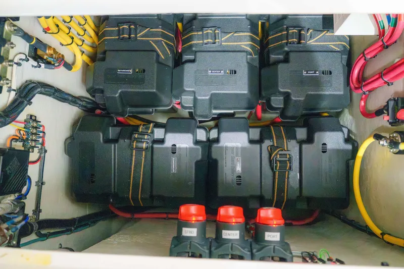 Slide: The Image of 2022 SeaVee 370Z battery compartment with organized wiring and labeled switches. - 35