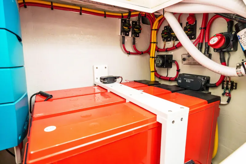Slide: The Image of 2022 SeaVee 370Z boat battery compartment with wiring and electrical components. - 37