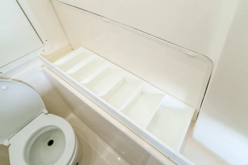 Slide: The Image of Interior of 2022 SeaVee 370Z boat bathroom with toilet and storage compartments. - 39