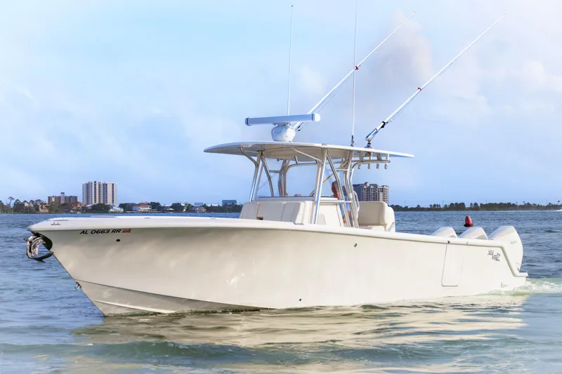 Slide: The Image of 2022 SeaVee 370Z boat cruising on water with cityscape background. - 6
