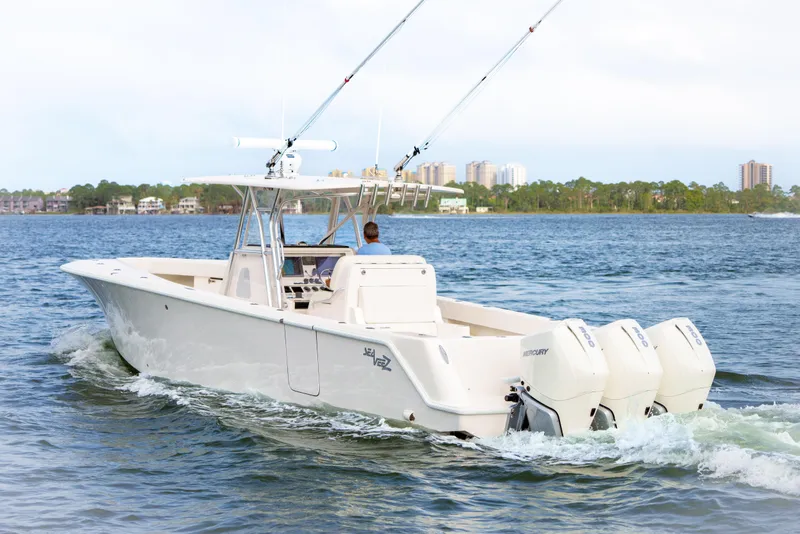 Slide: The Image of 2022 SeaVee 370Z boat cruising on water with triple Mercury engines. - 7