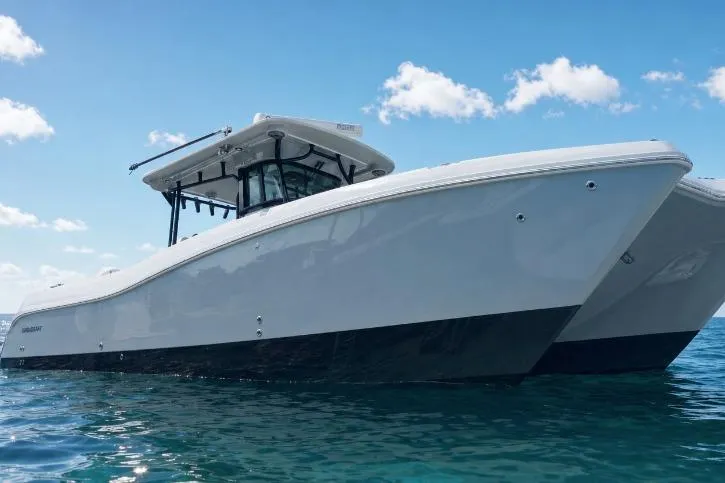 The Image of 2020 World Cat 325 CC boat on clear blue water under a sunny sky. - 0