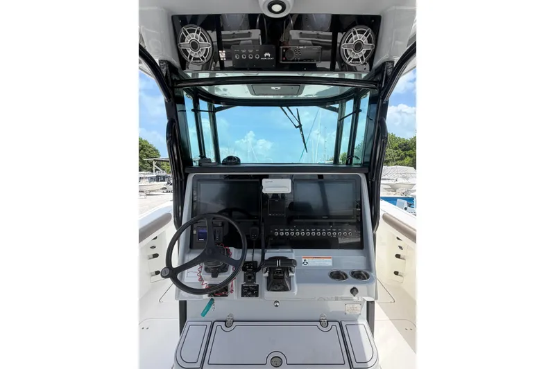 Slide: The Image of Cockpit of 2020 World Cat 325 CC boat with steering wheel and control panel. - 10