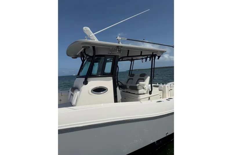 Slide: The Image of 2020 World Cat 325 CC boat on water, featuring sleek design and modern amenities. - 16