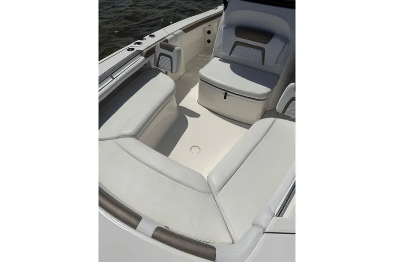 Slide: The Image of 2020 World Cat 325 CC boat interior with cushioned seating and storage. - 19