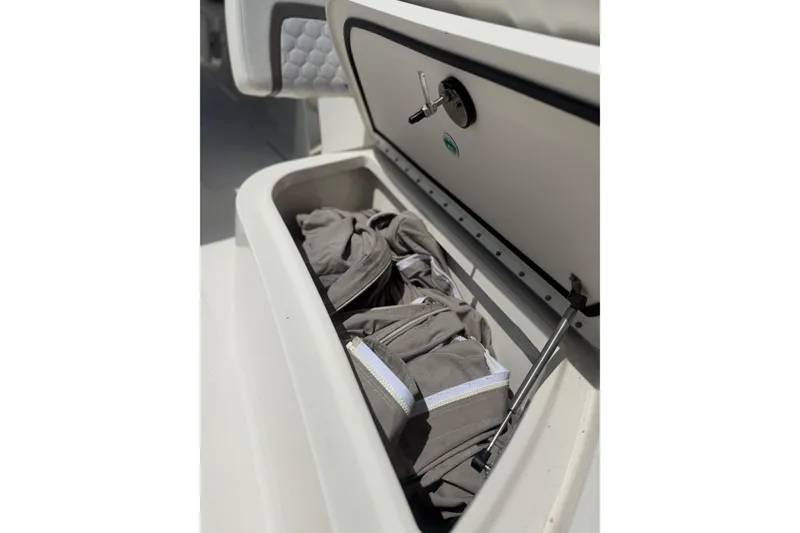 Slide: The Image of Storage compartment on a 2020 World Cat 325 CC boat, containing folded fabric. - 21