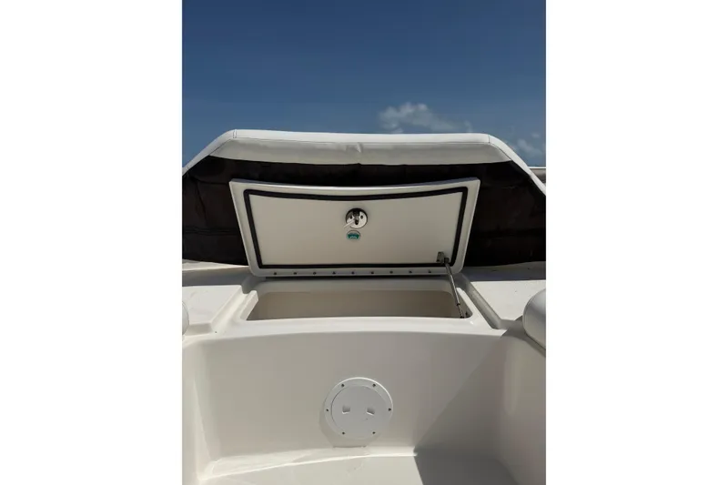 Slide: The Image of Open storage compartment on 2020 World Cat 325 CC boat under clear blue sky. - 22