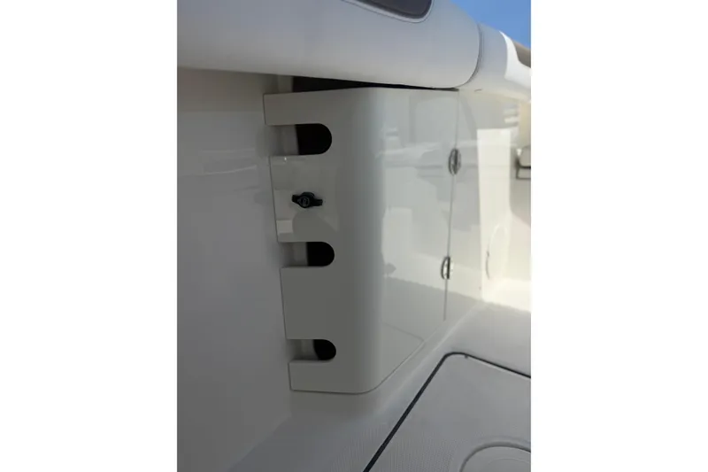 Slide: The Image of 2020 World Cat 325 CC boat interior detail with storage compartment and rod holders. - 27