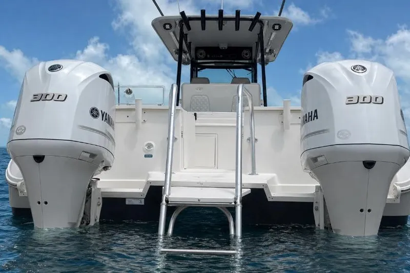 Slide: The Image of 2020 World Cat 325 CC boat with twin Yamaha 300 engines on water. - 3