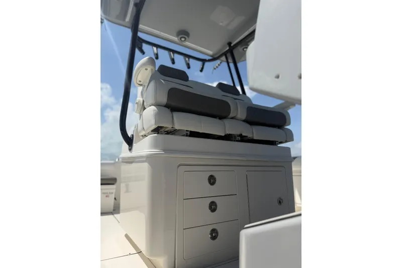 Slide: The Image of 2020 World Cat 325 CC boat interior with cushioned seating and storage drawers. - 31