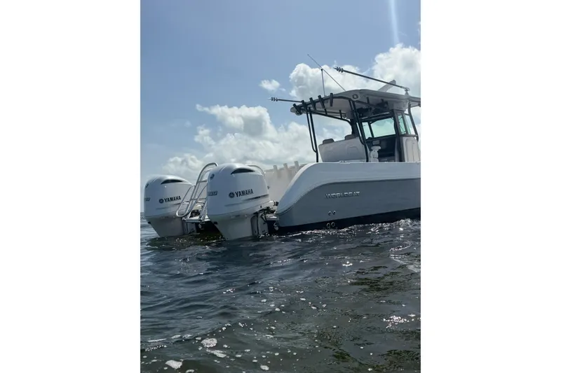 Slide: The Image of 2020 World Cat 325 CC boat with Yamaha engines on water, under a clear sky. - 37